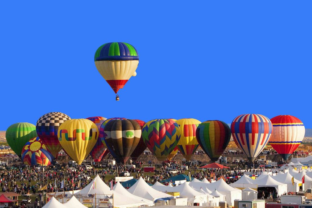 hot-air-balloon-floating-above-others-at-festival--albuquerque--new-mexico--united-states-519516855-49736bd02de1434490196a20820f1bbc