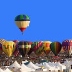 hot-air-balloon-floating-above-others-at-festival--albuquerque--new-mexico--united-states-519516855-49736bd02de1434490196a20820f1bbc